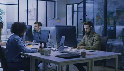 Workers in Office Working on PCs